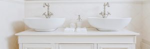 Two elegant washbasins in expensive bathroom in white